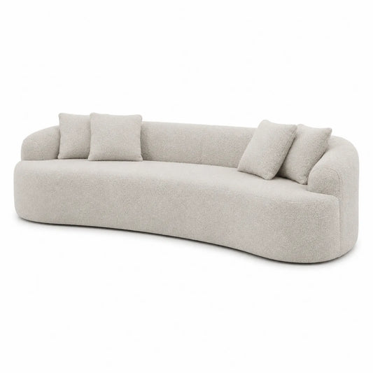 Canapé courbé en tissu bouclé beige avec coussins